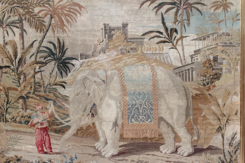 A VICTORIAN WOOLWORK PICTURE worked in half cross stitch with an elephant and its mahout in a Image
