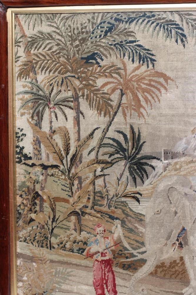 A VICTORIAN WOOLWORK PICTURE worked in half cross stitch with an elephant and its mahout in a Image