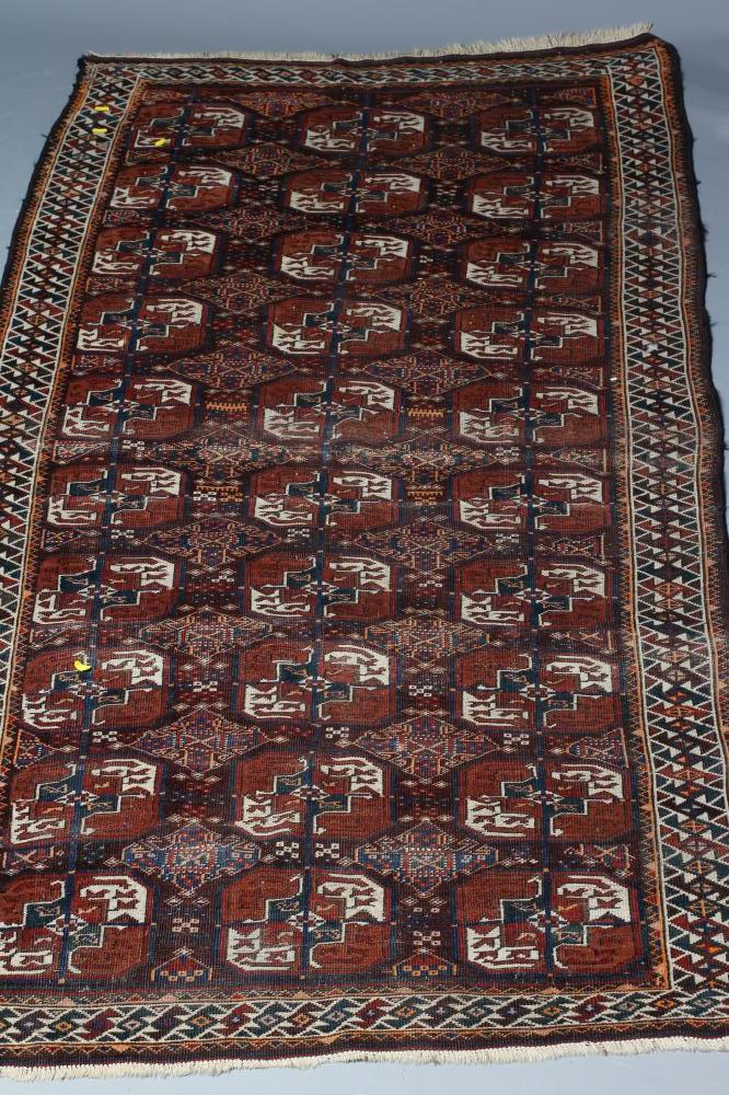 A TURKOMAN RUG, early/mid 20th century, finely woven with three rows of repeating linked quartered Image
