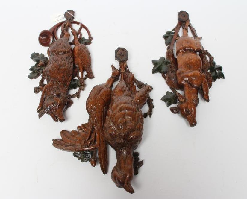 THREE EUROPEAN CARVED AND STAINED OAK WALL APPLIQUES, early 20th century, depicting hanging game Image