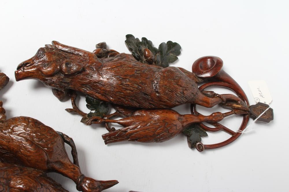 THREE EUROPEAN CARVED AND STAINED OAK WALL APPLIQUES, early 20th century, depicting hanging game Image