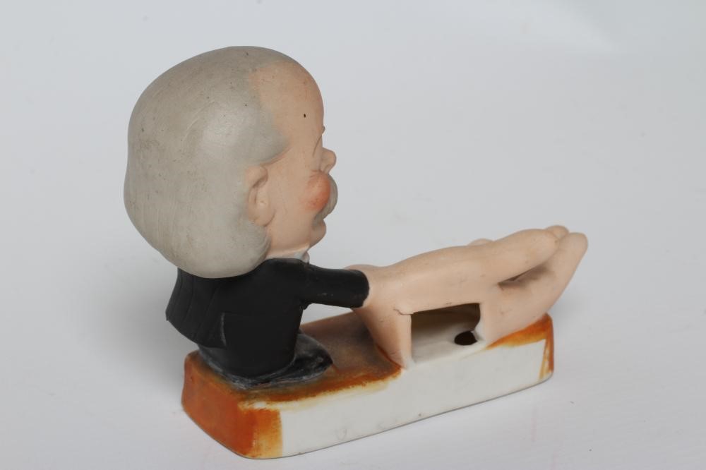 OF BRITISH POLITICAL INTEREST- a German bisque porcelain novelty match holder Image
