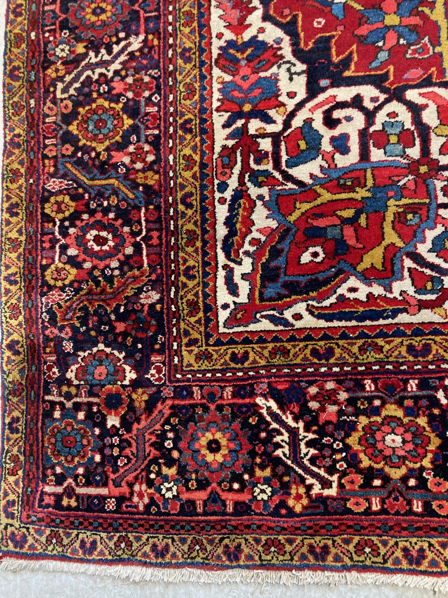 AN HERIZ CARPET, mid 20th century, the terracotta field with central flowerhead medallion bordered Image