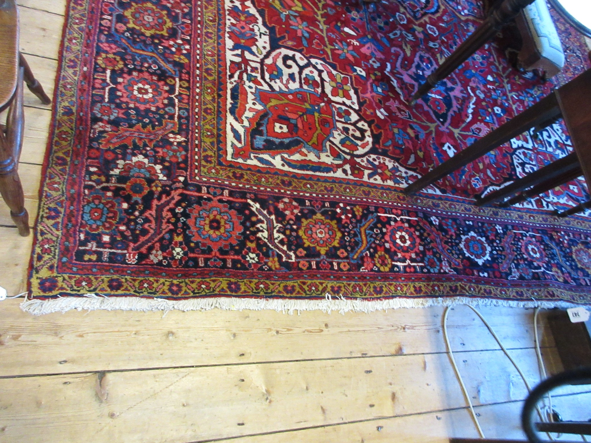 AN HERIZ CARPET, mid 20th century, the terracotta field with central flowerhead medallion bordered Image