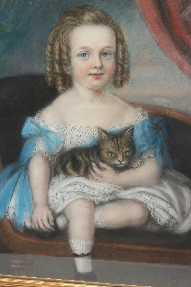 BRITISH SCHOOL (Late 19th Century) Portrait of a Girl with a Cat, half length, seated wearing a blue Image