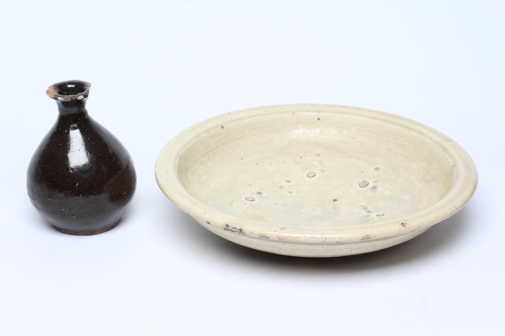 A CHINESE CELADON GLAZED STONEWARE SHALLOW BOWL of plain circular form Image