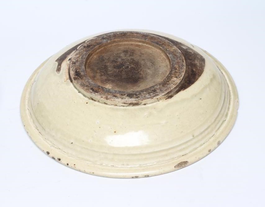 A CHINESE CELADON GLAZED STONEWARE SHALLOW BOWL of plain circular form Image