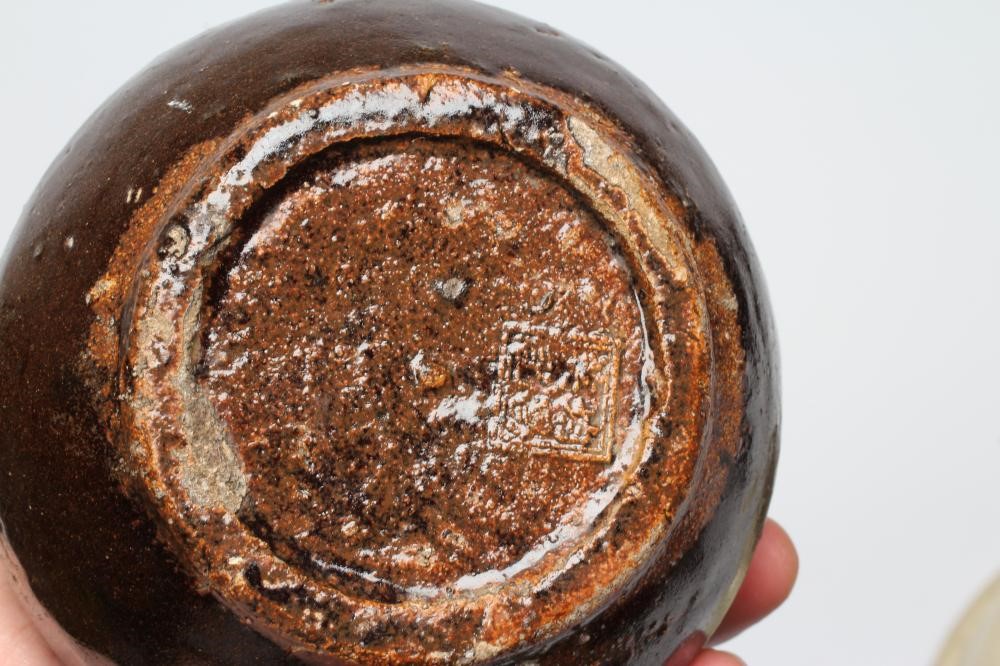 A CHINESE CELADON GLAZED STONEWARE SHALLOW BOWL of plain circular form Image