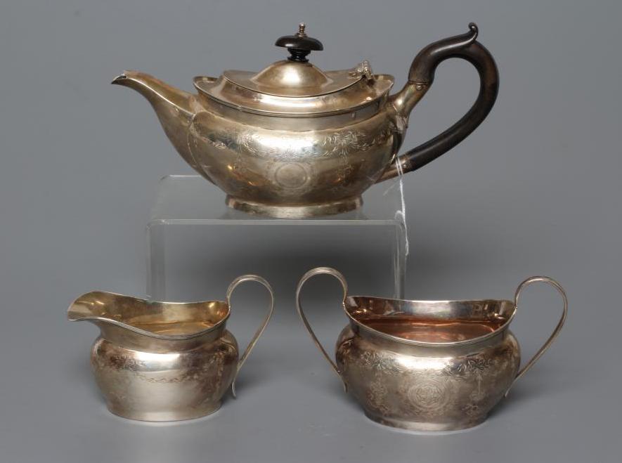 A BACHELOR'S EDWARDIAN SILVER THREE PIECE TEA SERVICE Image