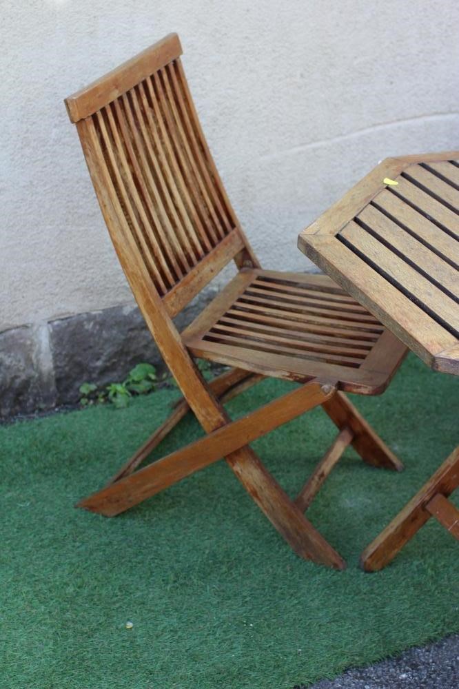 A SLATTED HARDWOOD DINING SUITE, comprising folding octagonal table, 43 1/2" wide, ensuite with four Image