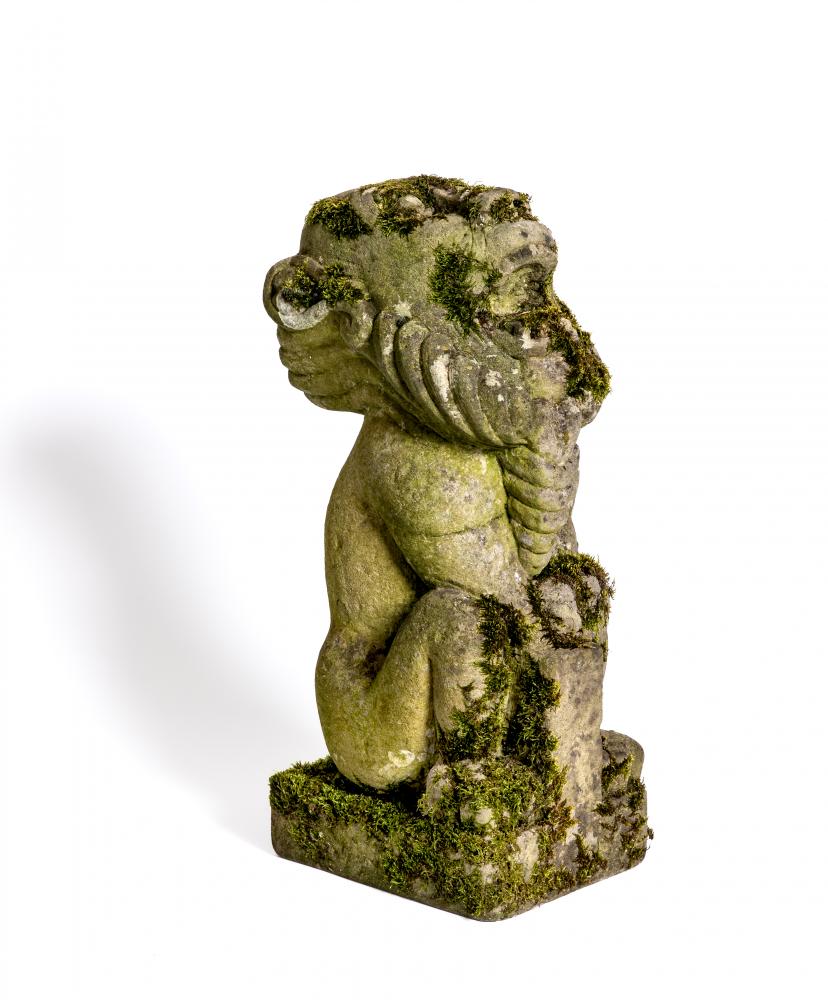 A CARVED SANDSTONE BEARDED GARGOYLE modelled seated with paw feet and open mouth, 7" x 20 1/2" Image