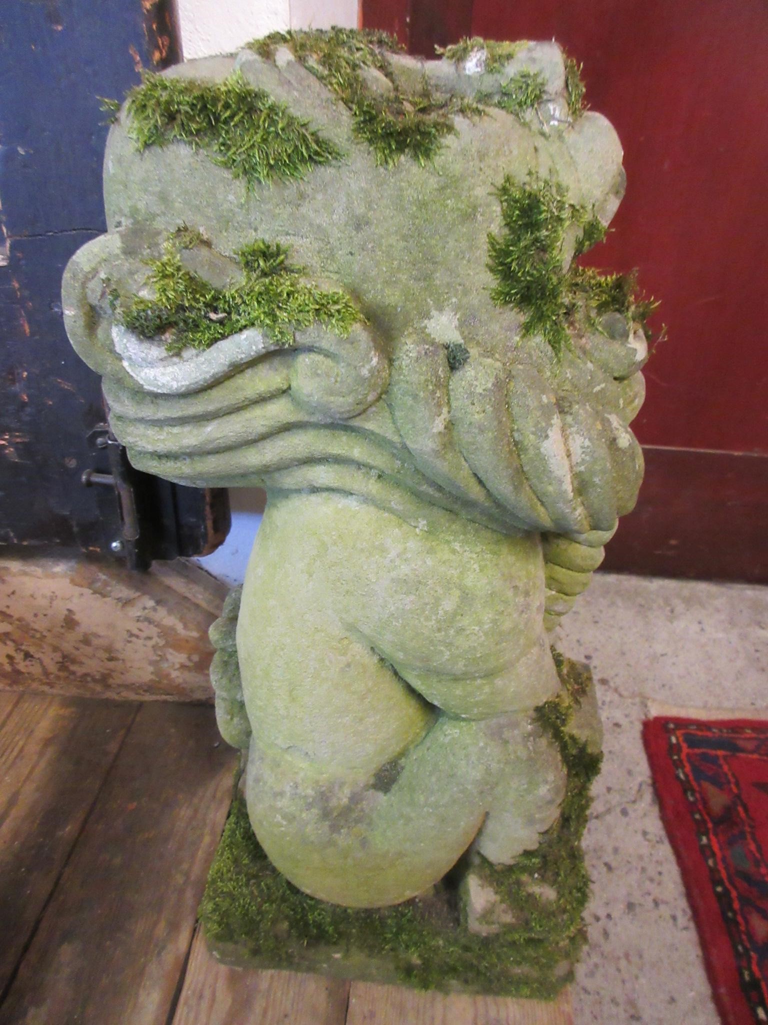 A CARVED SANDSTONE BEARDED GARGOYLE modelled seated with paw feet and open mouth, 7" x 20 1/2" Image