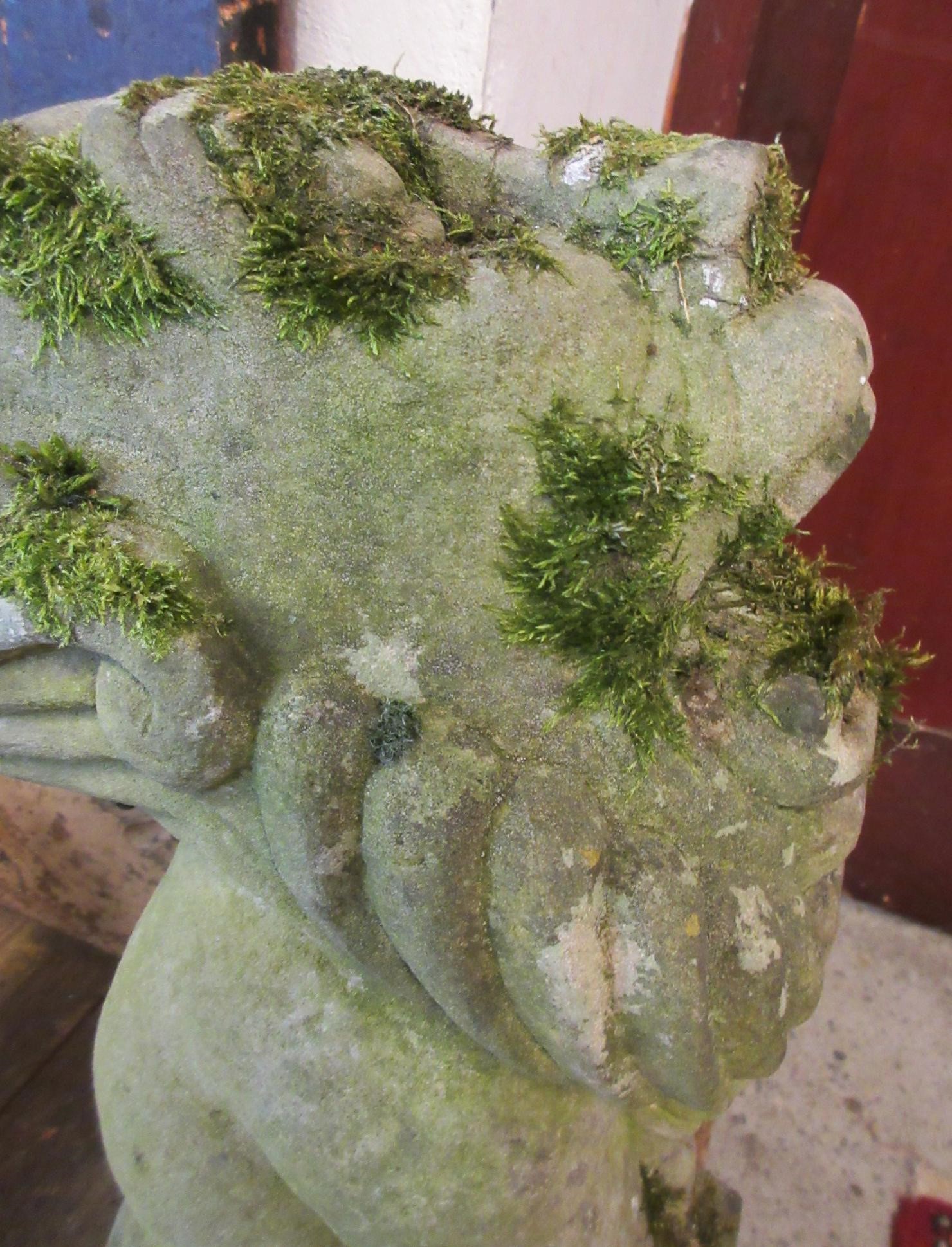 A CARVED SANDSTONE BEARDED GARGOYLE modelled seated with paw feet and open mouth, 7" x 20 1/2" Image