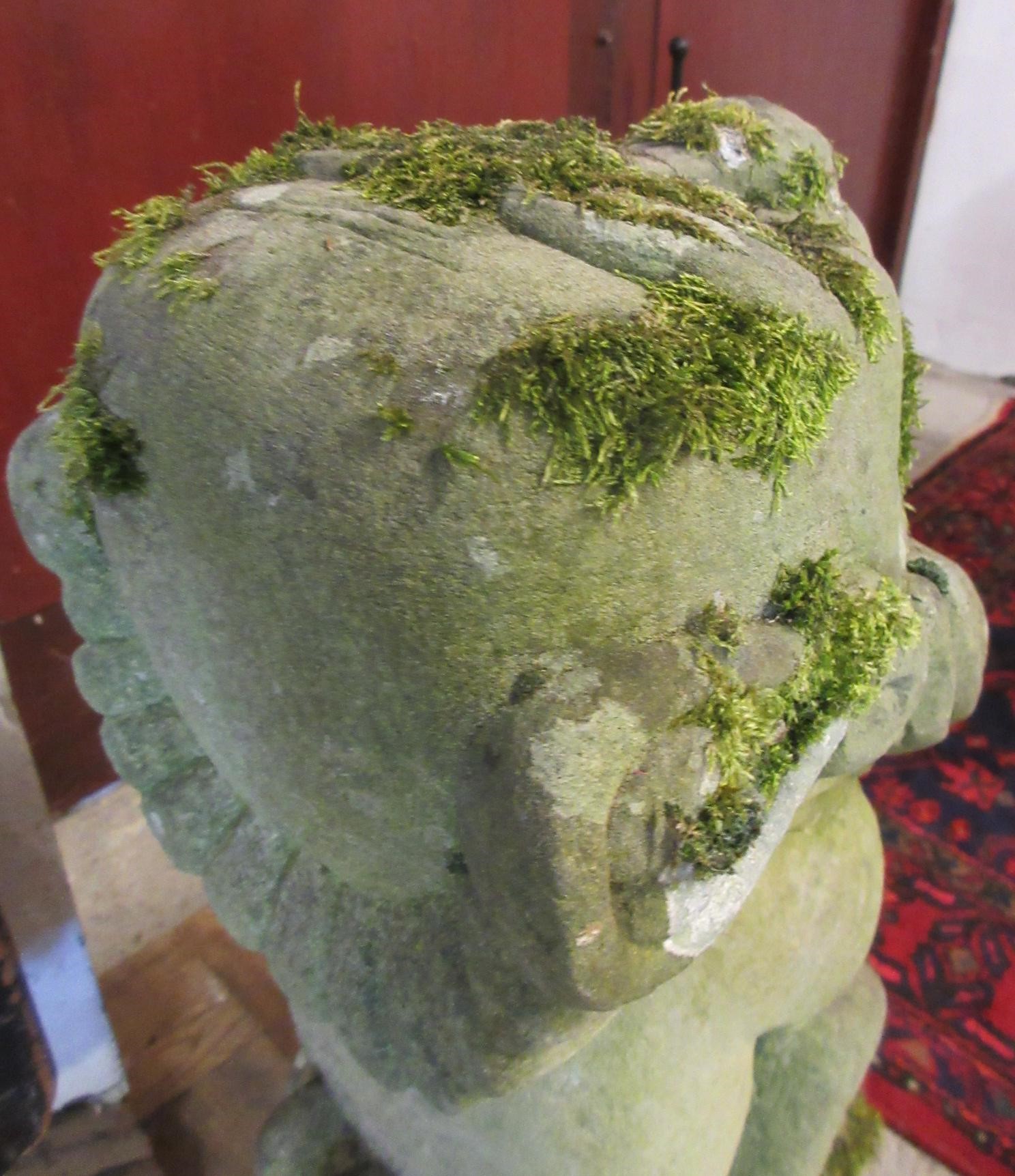 A CARVED SANDSTONE BEARDED GARGOYLE modelled seated with paw feet and open mouth, 7" x 20 1/2" Image