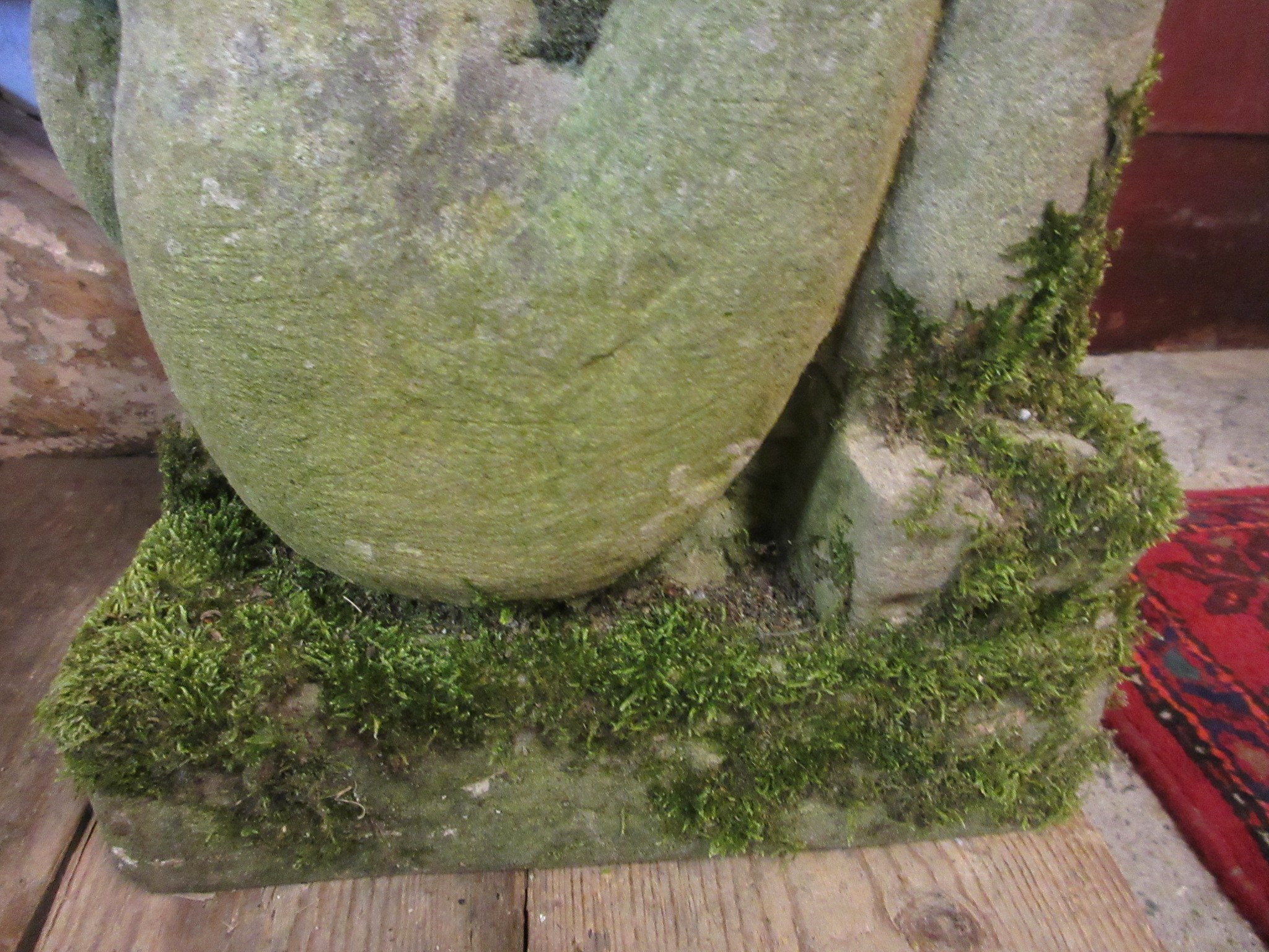 A CARVED SANDSTONE BEARDED GARGOYLE modelled seated with paw feet and open mouth, 7" x 20 1/2" Image