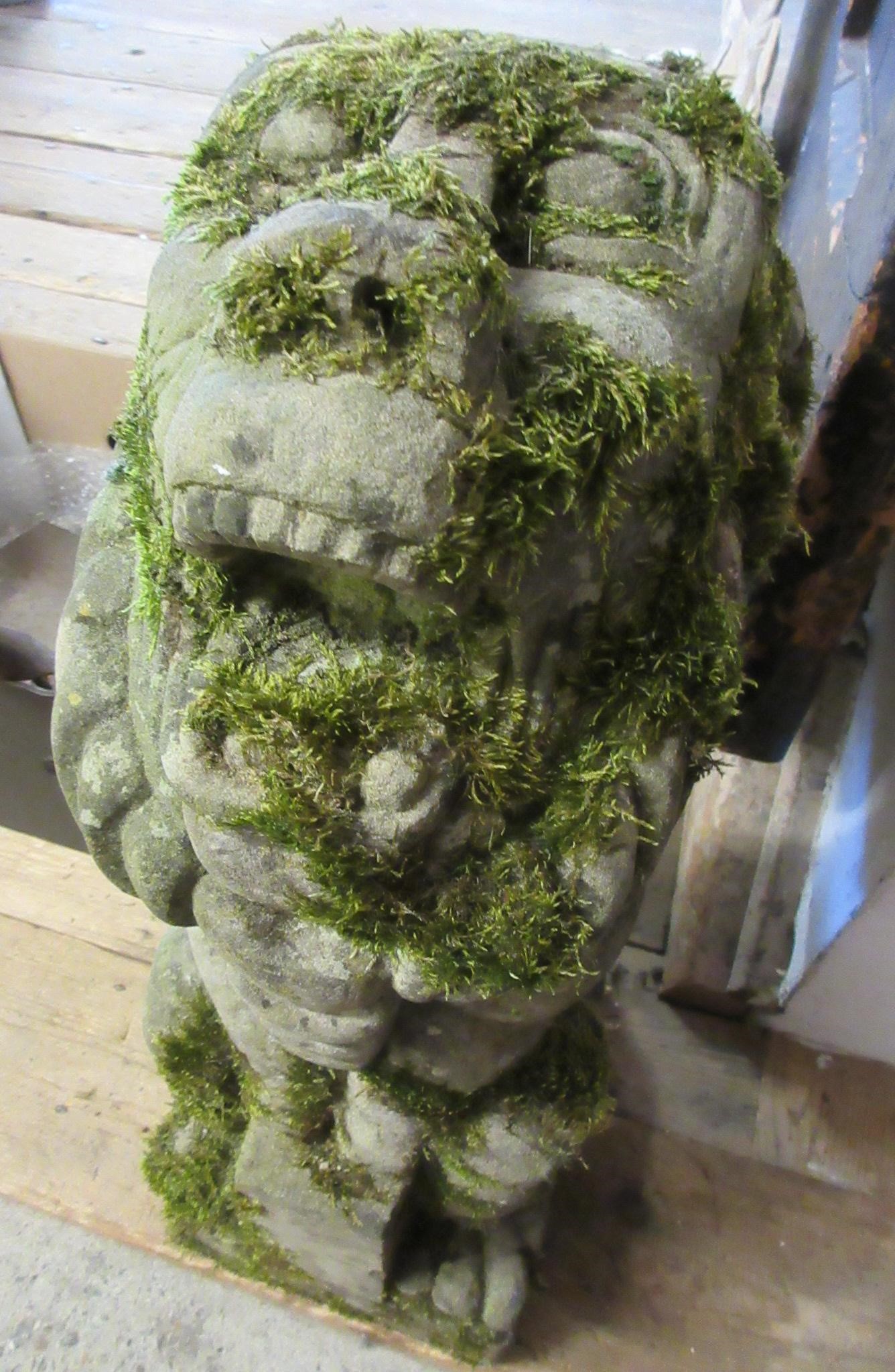 A CARVED SANDSTONE BEARDED GARGOYLE modelled seated with paw feet and open mouth, 7" x 20 1/2" Image