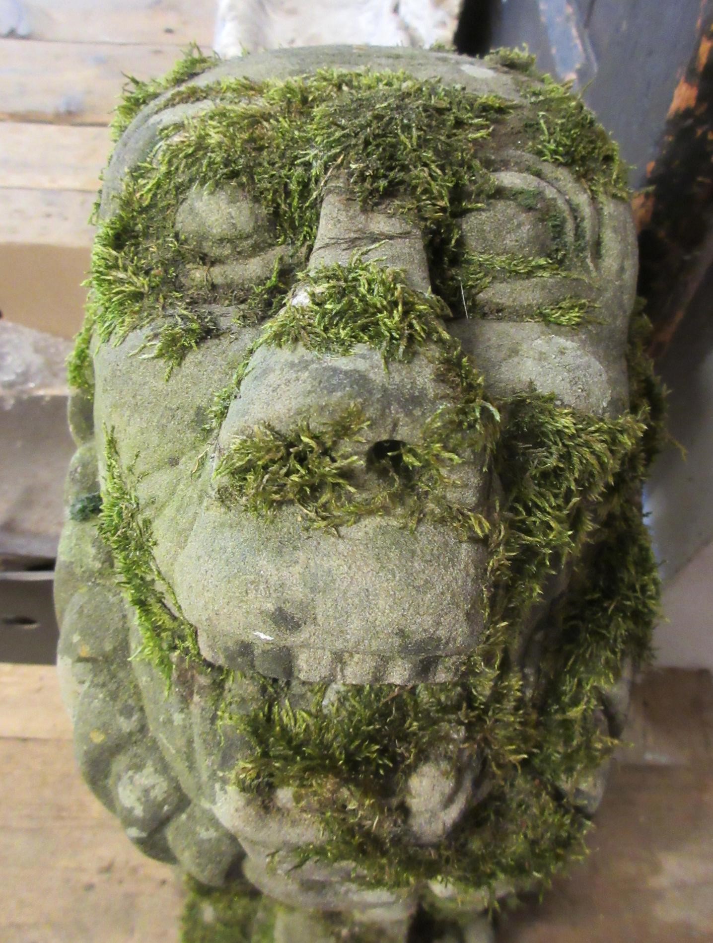 A CARVED SANDSTONE BEARDED GARGOYLE modelled seated with paw feet and open mouth, 7" x 20 1/2" Image