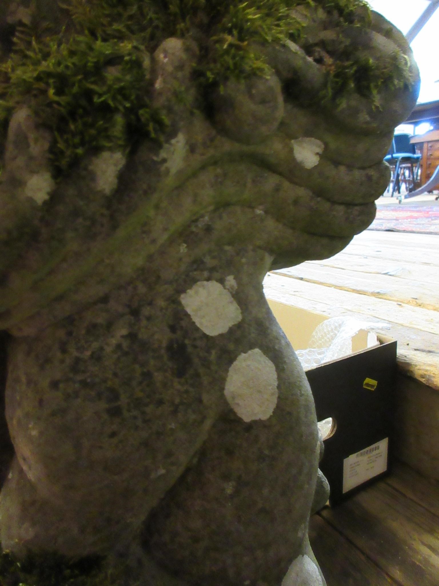 A CARVED SANDSTONE BEARDED GARGOYLE modelled seated with paw feet and open mouth, 7" x 20 1/2" Image