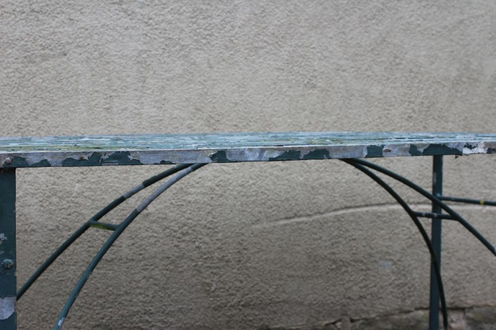 A GALAVANISED METAL STRAPWORK TABLE of oblong form with end supports joined by an arched stretcher, Image