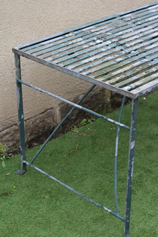 A GALAVANISED METAL STRAPWORK TABLE of oblong form with end supports joined by an arched stretcher, Image