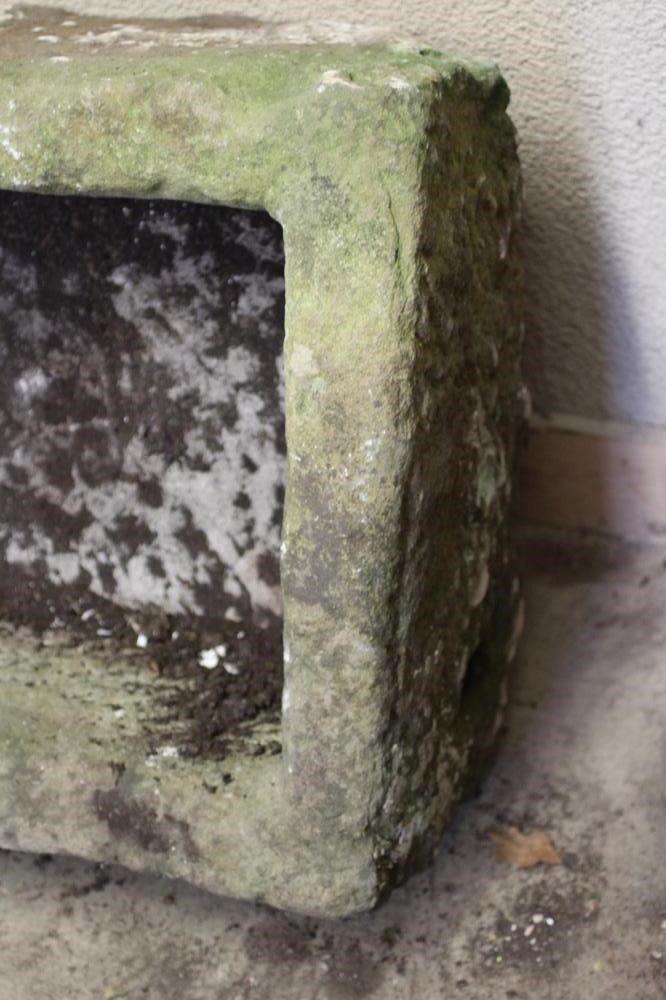 A SANDSTONE TROUGH of rough hewn oblong form, 29 1/2" x 23 1/2" x 16 1/2" (Est. plus 24% premium Image