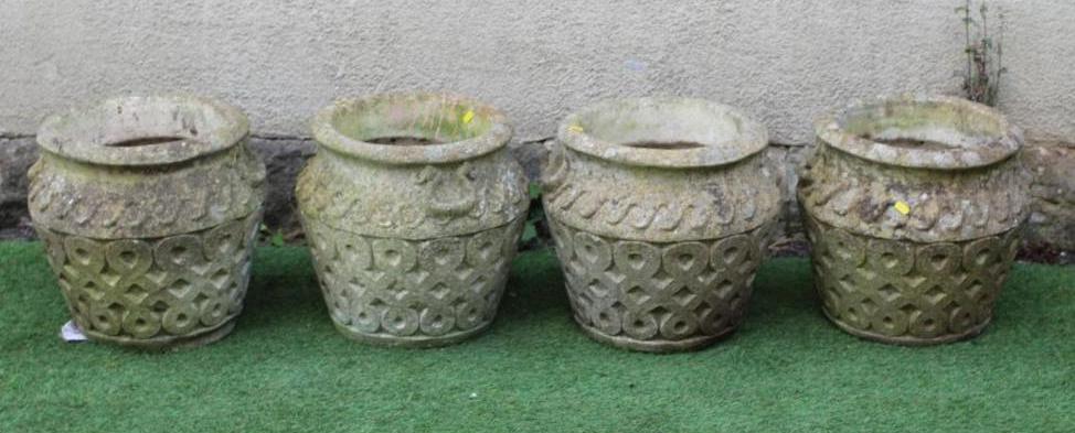 A SET OF FOUR CAST STONE PLANTERS of ovoid form with flared rim, the body with Vitruvian scroll Image