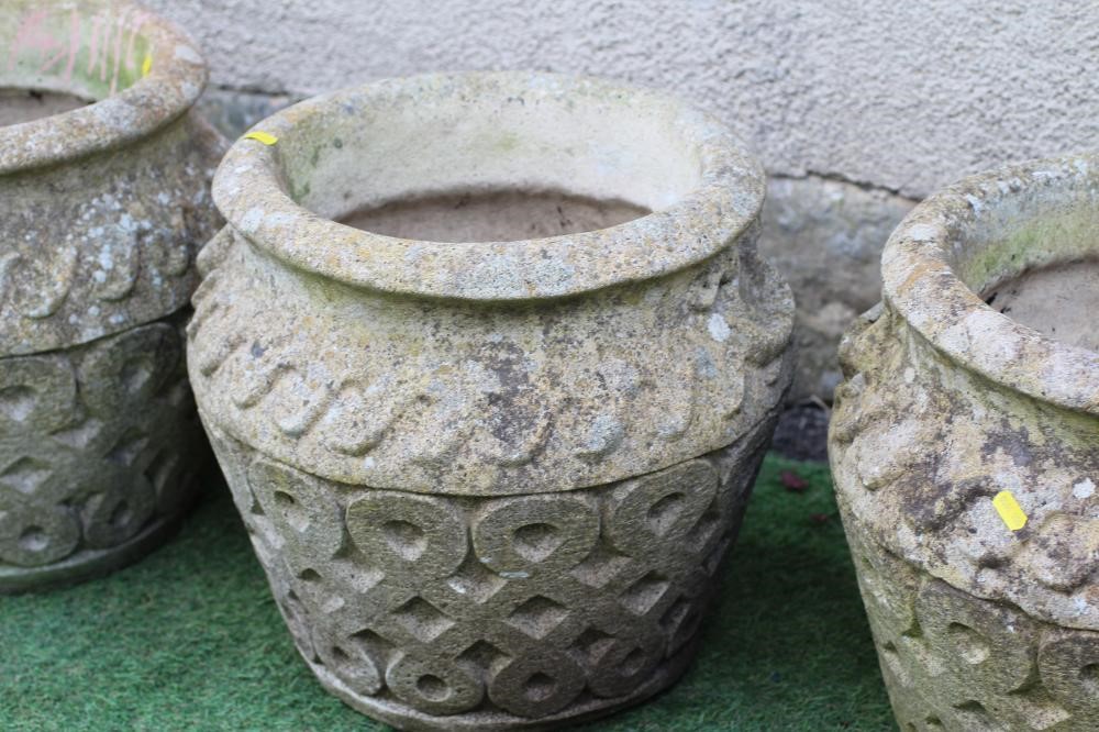 A SET OF FOUR CAST STONE PLANTERS of ovoid form with flared rim, the body with Vitruvian scroll Image