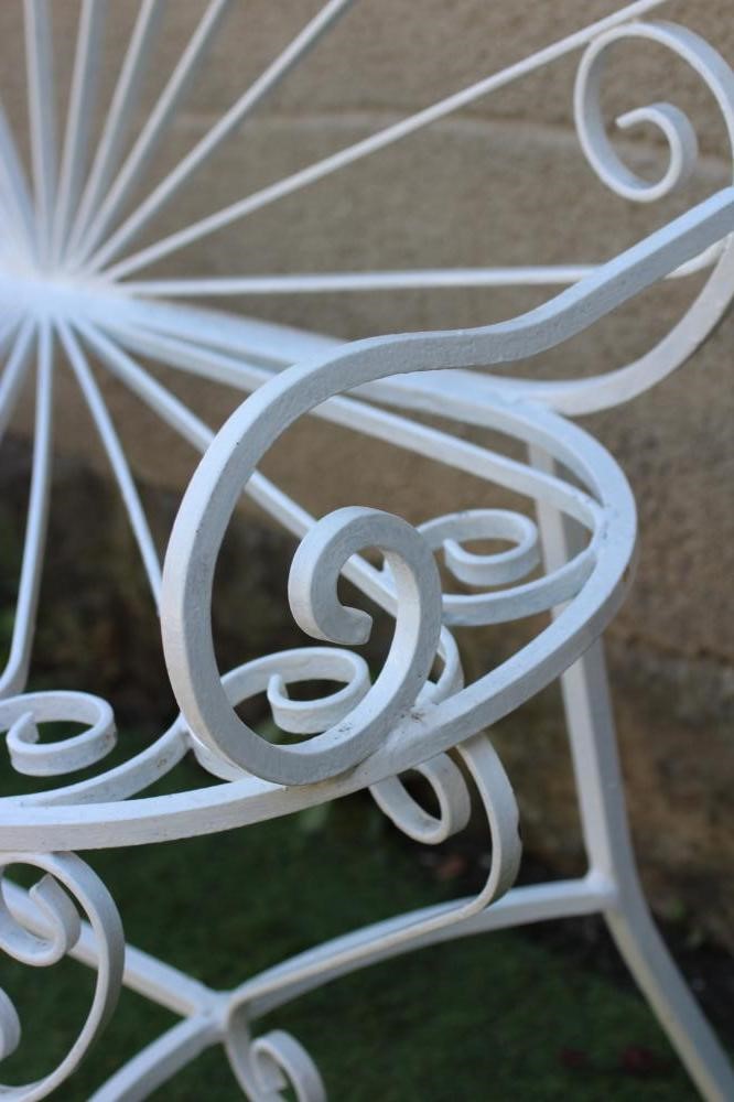 A CAST AND WROUGHT METAL BENCH, with arched sunburst back and corresponding metal seat, scrolled arm Image