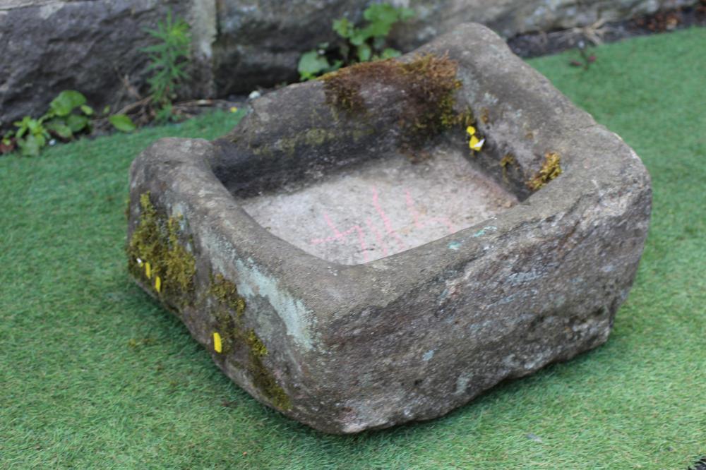 A SMALL SANDSTONE TROUGH of rough hewn oblong form, 21" x 17 1/2" x 8 1/2" (Est. plus 24% premium Image