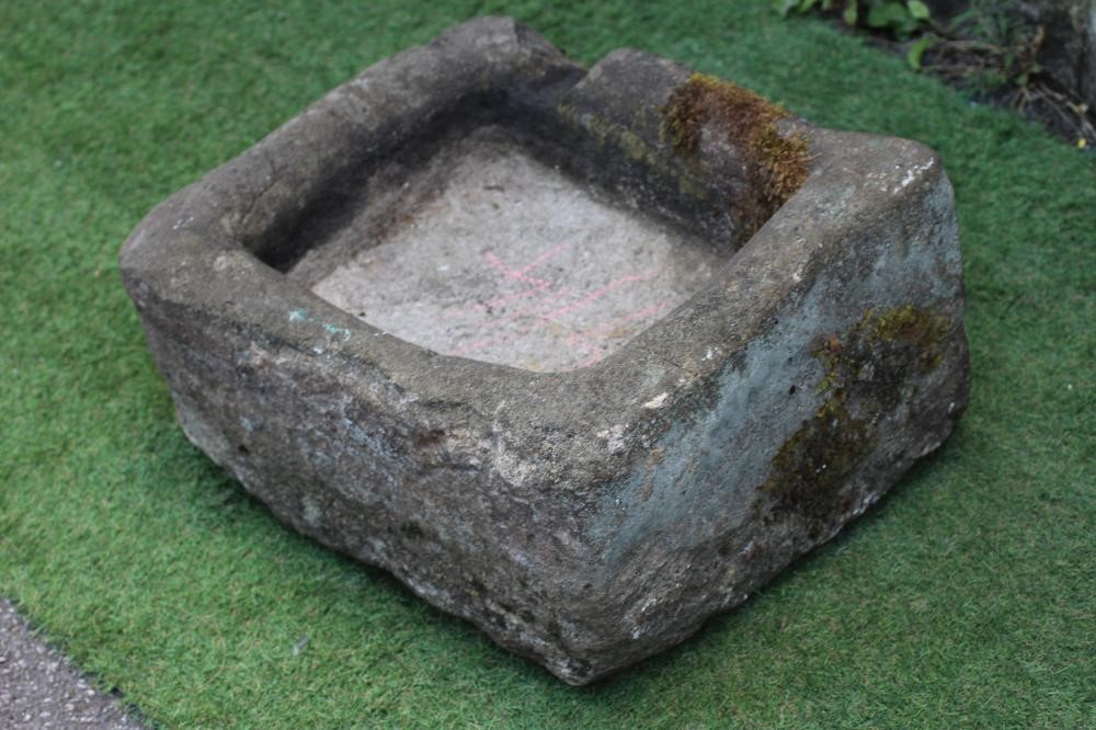A SMALL SANDSTONE TROUGH of rough hewn oblong form, 21" x 17 1/2" x 8 1/2" (Est. plus 24% premium Image