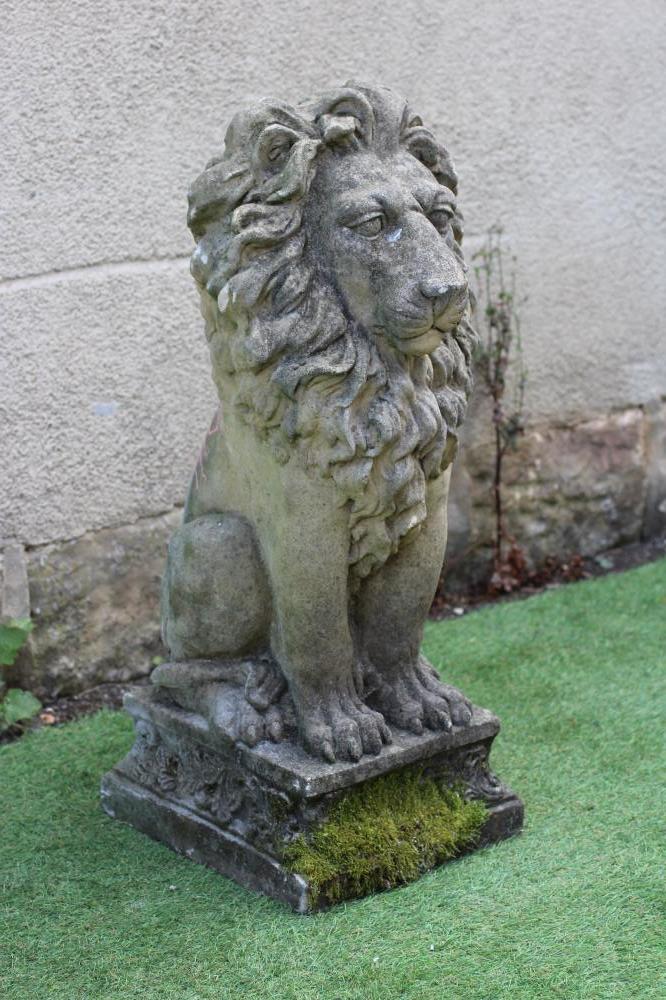 A CAST STONE LION SEJANT on waisted leaf moulded square base, 12" x 32 1/2" (Est. plus 24% premium Image