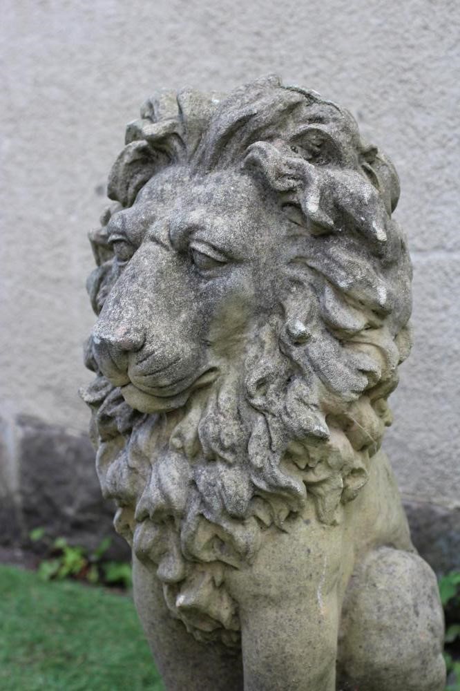 A CAST STONE LION SEJANT on waisted leaf moulded square base, 12" x 32 1/2" (Est. plus 24% premium Image