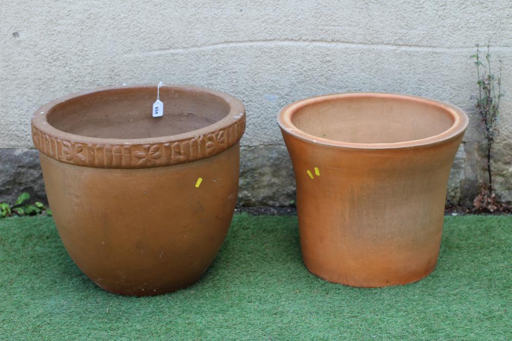 A STONEWARE PLANT POT, the ribbed rim spaced with star motifs, 22" x 18 1/2", together with a plain Image