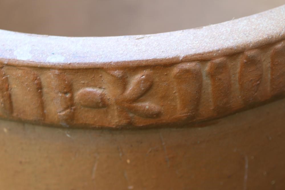 A STONEWARE PLANT POT, the ribbed rim spaced with star motifs, 22" x 18 1/2", together with a plain Image