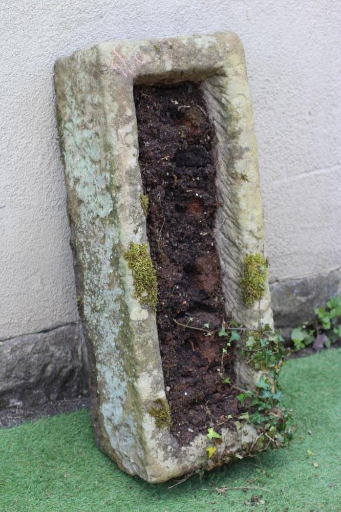 A SANDSTONE TROUGH of rough hewn oblong form with mildly tapering sides, 37 1/2" x 15" x 9 1/2" Image