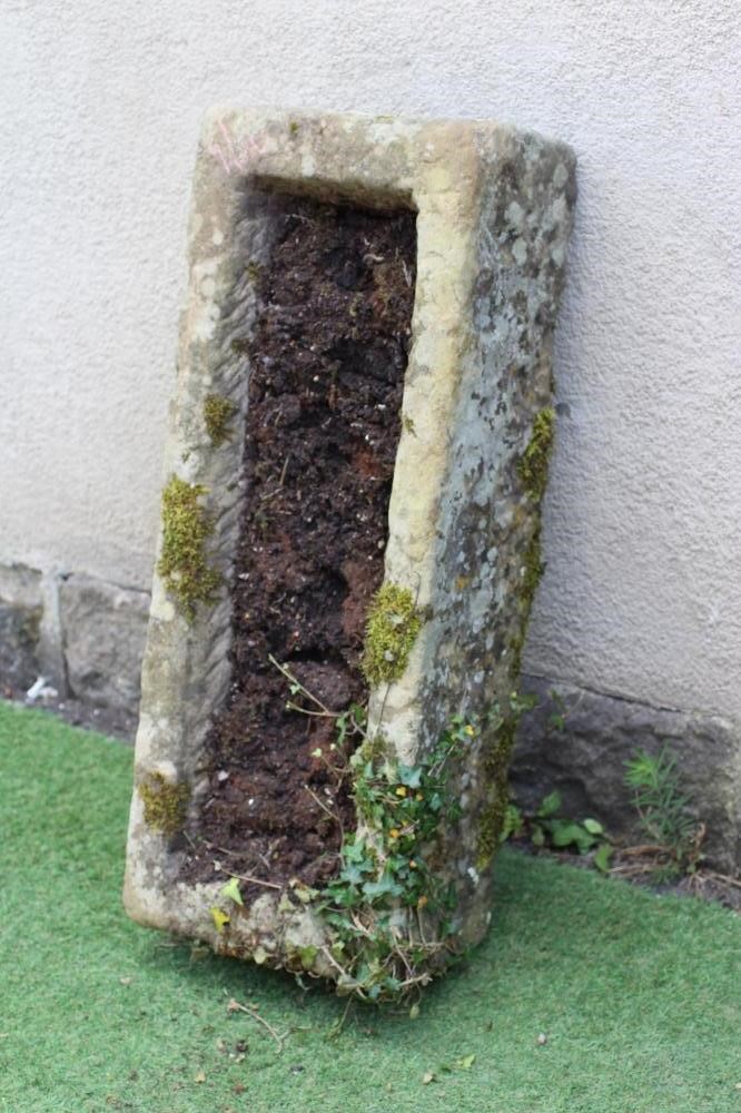 A SANDSTONE TROUGH of rough hewn oblong form with mildly tapering sides, 37 1/2" x 15" x 9 1/2" Image