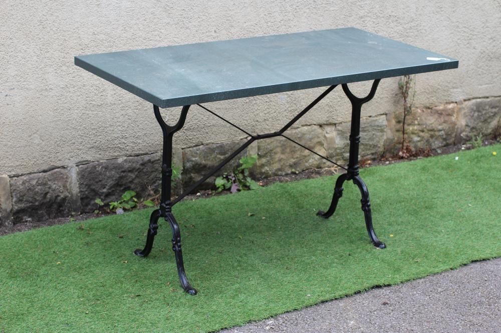 A CONSERVATORY/DINING TABLE, modern, the oblong green "quartz" top on scrolled cast metal end Image
