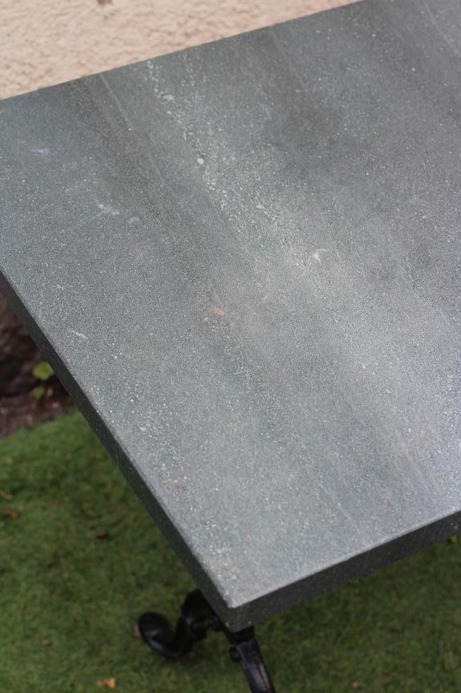 A CONSERVATORY/DINING TABLE, modern, the oblong green "quartz" top on scrolled cast metal end Image