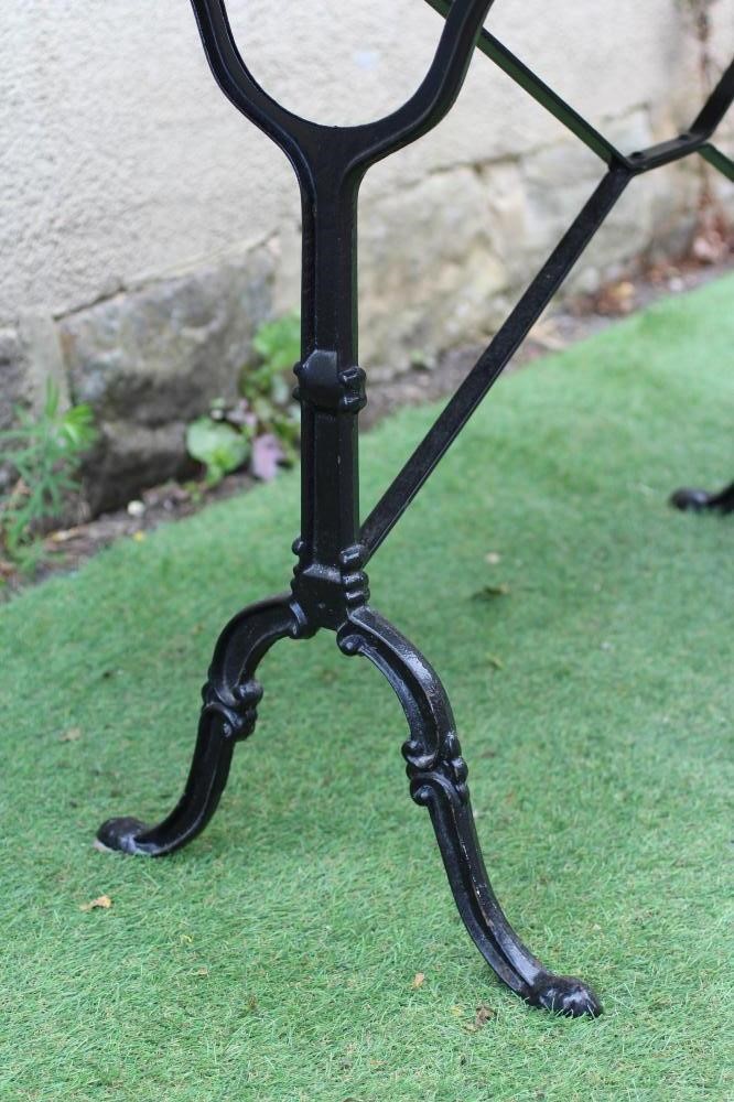 A CONSERVATORY/DINING TABLE, modern, the oblong green "quartz" top on scrolled cast metal end Image