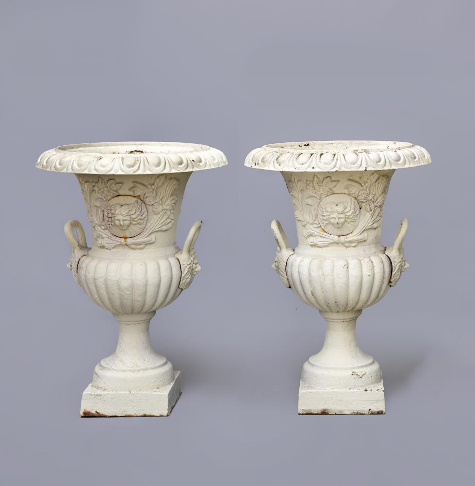 A PAIR OF LARGE CAST IRON URNS of half fluted campana form with lion mask handles Image