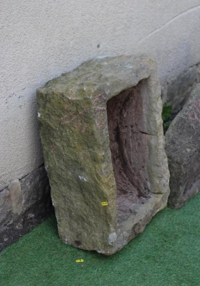 A SMALL SANDSTONE TROUGH of rough hewn oblong form 23" x 18 1/2" x 9" Image