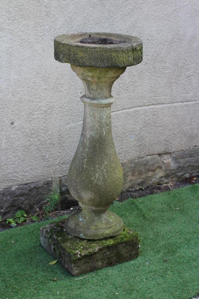 A SANDSTONE BIRD BATH, the circular bowl on baluster turned stem and square base, 16" x 42" (Est. Image