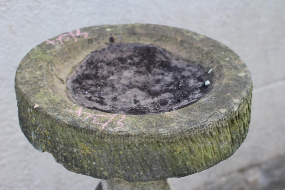 A SANDSTONE BIRD BATH, the circular bowl on baluster turned stem and square base, 16" x 42" (Est. Image