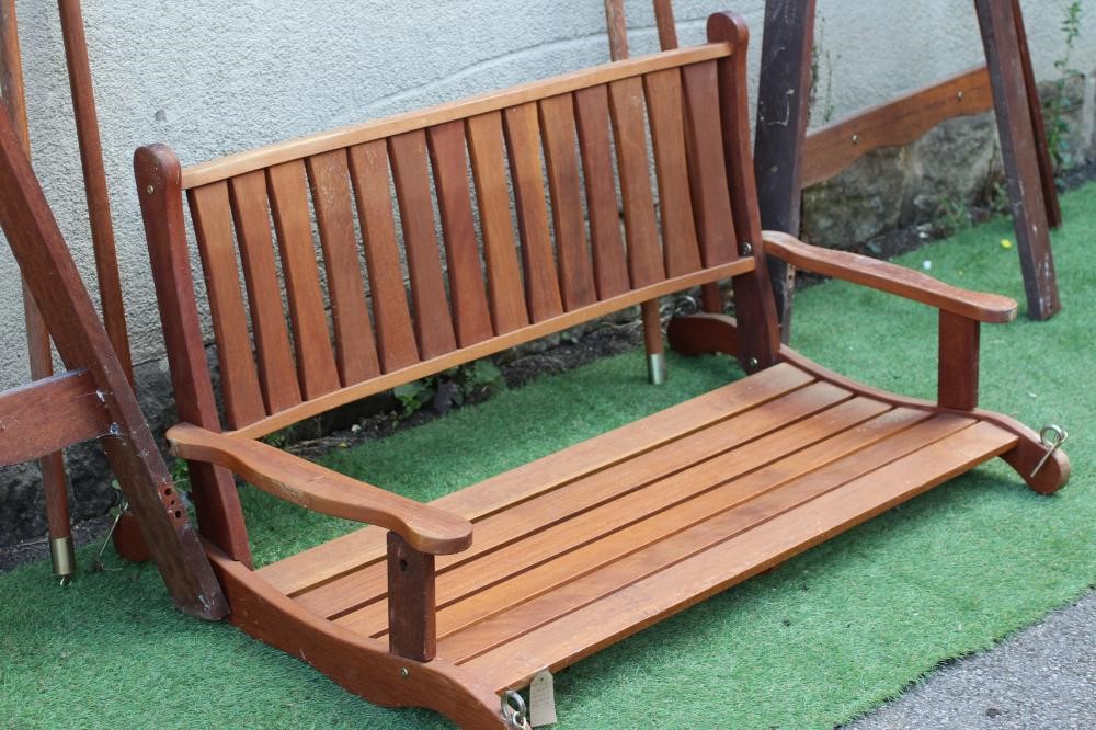 A SLATTED TEAK SWING GARDEN BENCH, modern, the mildly curved back with straight top rail, shaped Image