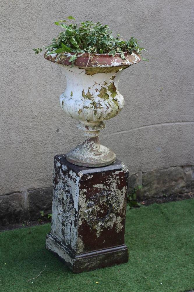 A TERRACOTTA URN of half fluted campana form on moulded circular base, raised on associated salt Image