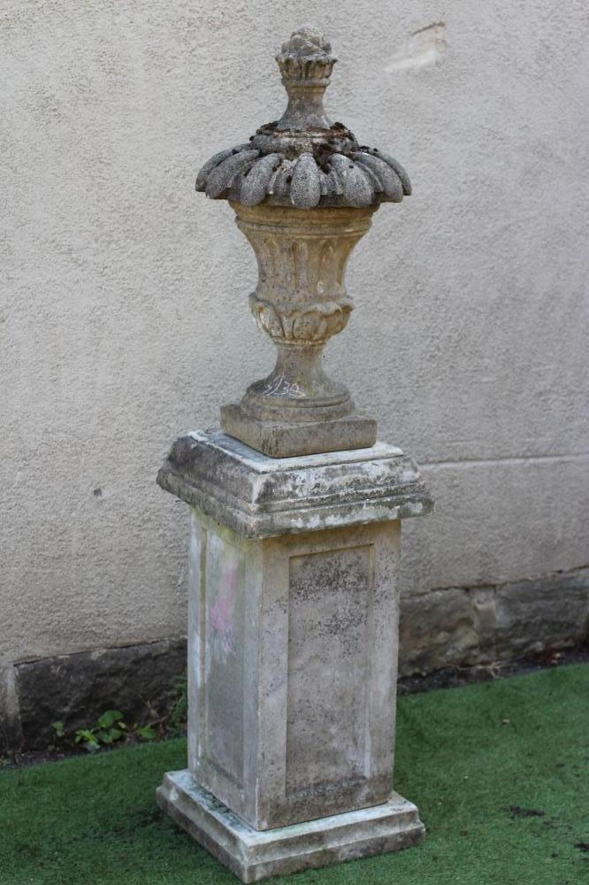 A CAST STONE LIDDED URN Image