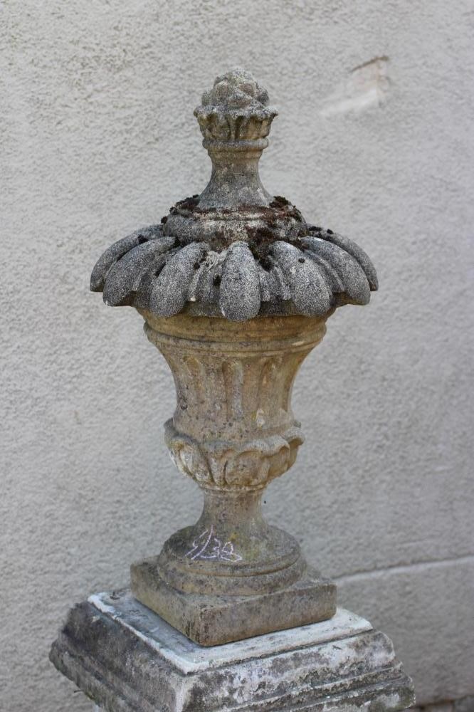 A CAST STONE LIDDED URN Image