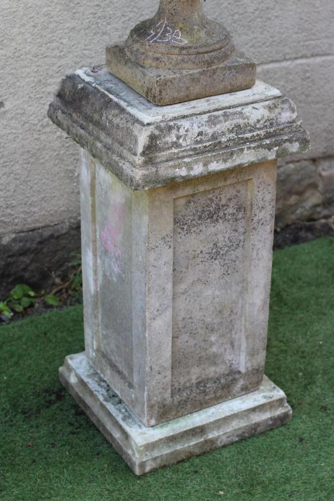 A CAST STONE LIDDED URN Image