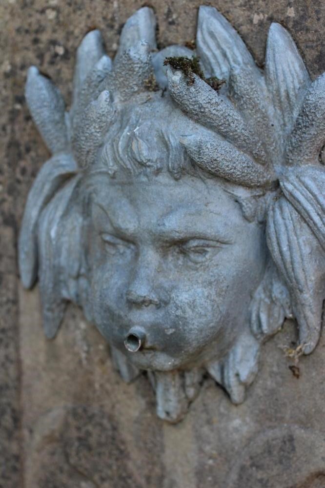 A CARVED SANDSTONE FOUNTAIN of square form with flat top Image