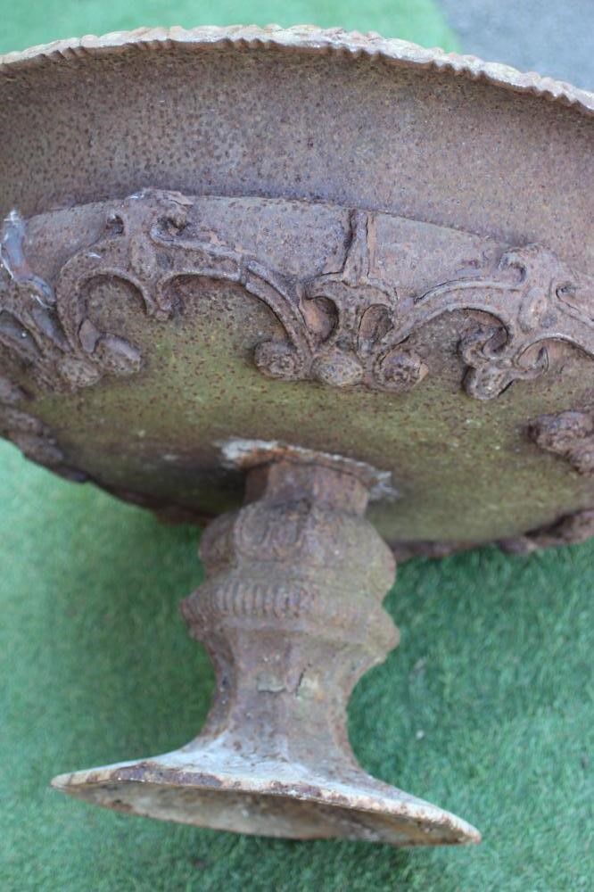 A VICTORIAN CAST IRON URN, the large shallow bowl with strapwork banding and egg and dart moulded Image